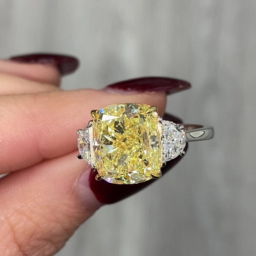GIA certified three piece ring with fancy yellow cushion diamonds and natural yellow diamonds with VS2 clarity.