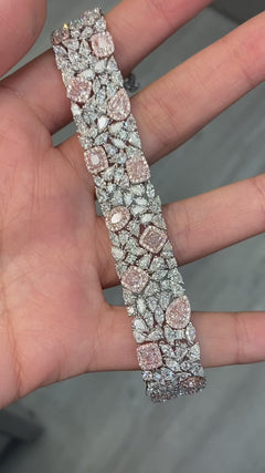 GIA certified light pink cushion and pear shape diamonds with white diamond bracelet.