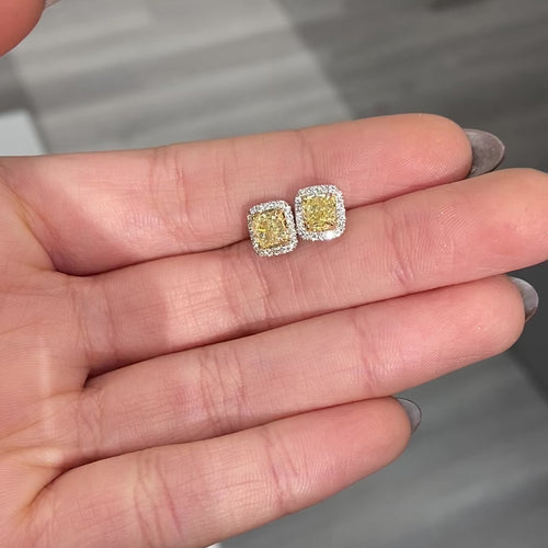 Fancy intense yellow cushion diamond studs with a F/VS2 clarity.