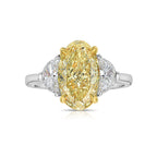 3ct Fancy intense Yellow Oval Three Stone Diamond Ring, a canary oval diamond.