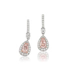 Ethereal natural light pink oval shaped elongated diamond earrings.