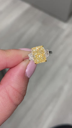 long radiant yellow diamond. Elongated yellow radiant diamond. Long radiant yellow. yellow diamond ring. yellow diamond 3 stone ring. GIA yellow diamond ring.