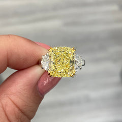 Elegant yellow diamond ring with a cushion-cut fancy yellow diamond and VS1 clarity.