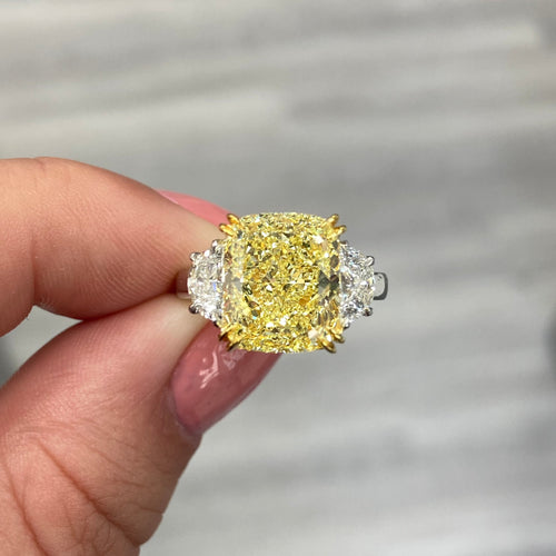 Elegant yellow diamond ring with a cushion-cut fancy yellow diamond and VS1 clarity.