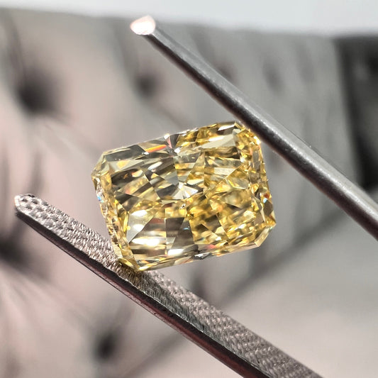 Elongated fancy intense yellow diamond radiant cut. Long yellow diamond radiant cut. Long radiant diamond.