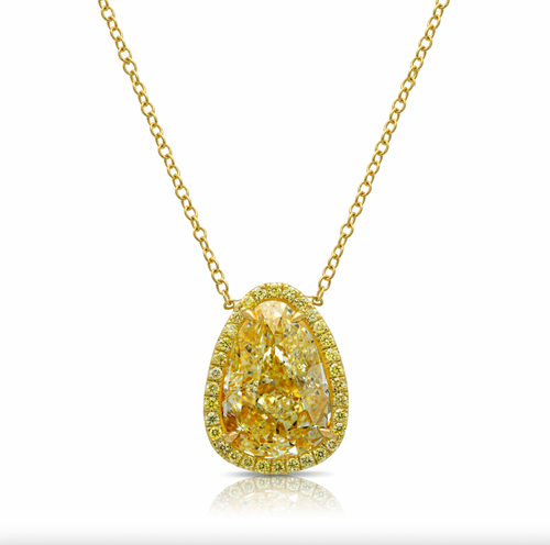 Old money light yellow pear-shaped diamond pendant, accented by a radiant halo of yellow diamonds with SI1 clarity.