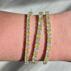 Alternating yellow and white diamond bracelet. tennis bracelet. alternating diamond bracelet. yellow diamond cushions.