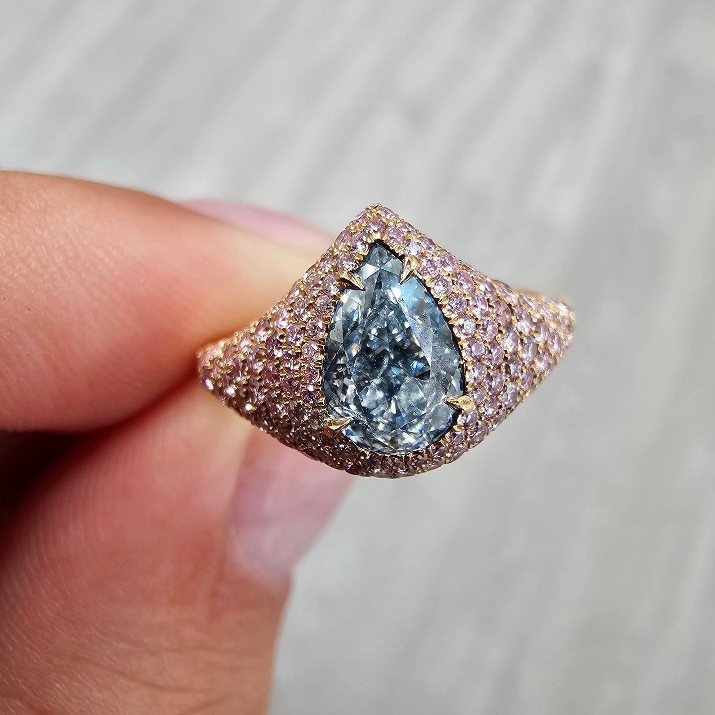 GIA light blue pear shape diamond ring set with natural pink diamonds