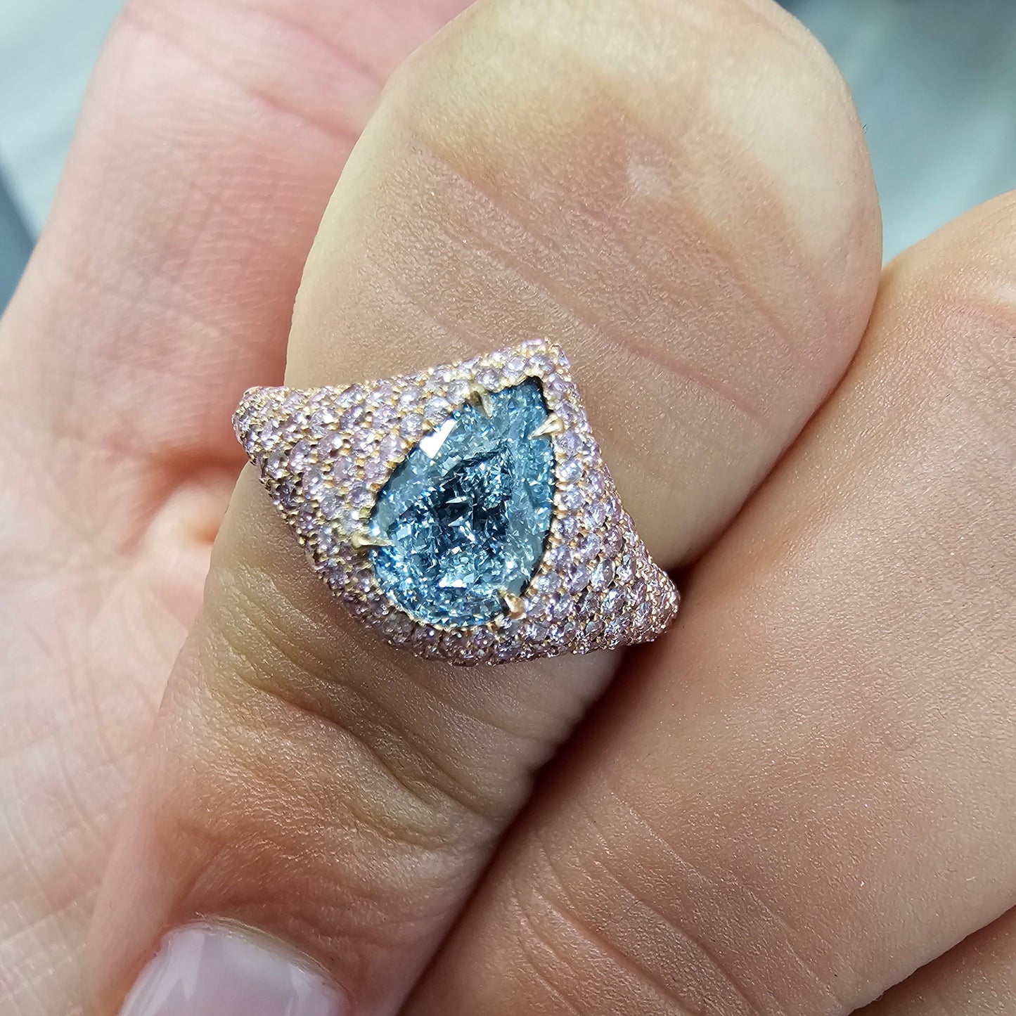 GIA light blue pear shape diamond ring set with natural pink diamonds