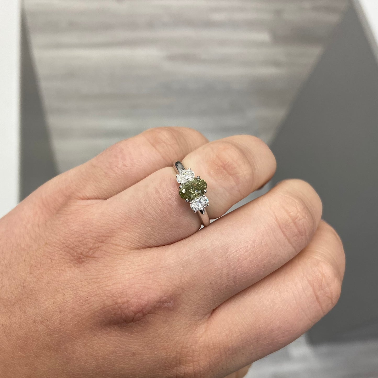 Color changing diamond, chameleon diamond, green diamond, J-Lo green diamond, three stone ring, unique engagement ring