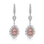 Ethereal pink diamond earrings. pink diamonds. pink diamond jewelry. pink diamond studs. pink diamond drop earrings. pink and white diamond earrings. pink diamond pear shapes.