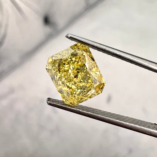 Fancy intense yellow elongated radiant. Long yellow radiant cut. Elongated radiant yellow diamond. Long radiant diamond.