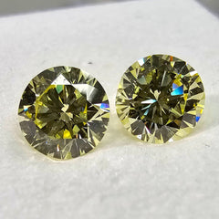 GIA certified matched pair of 2 round natural yellow diamonds.