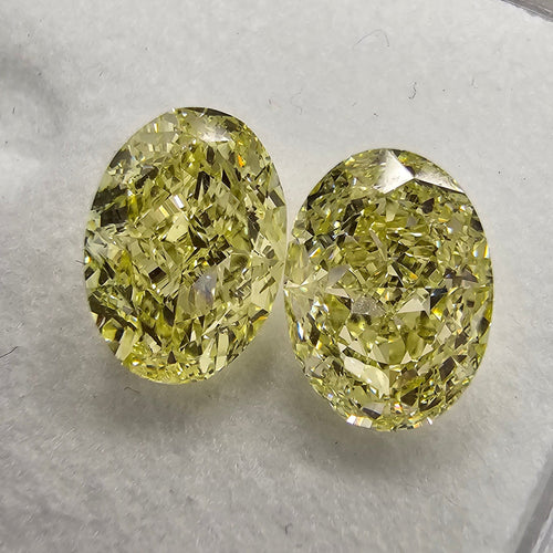 GIA certified matched pair of 2 natural yellow oval diamonds.