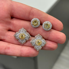 Light yellow and fancy light yellow diamond studs, in a flower theme with 1.5 carats of surrounding white and yellow diamonds