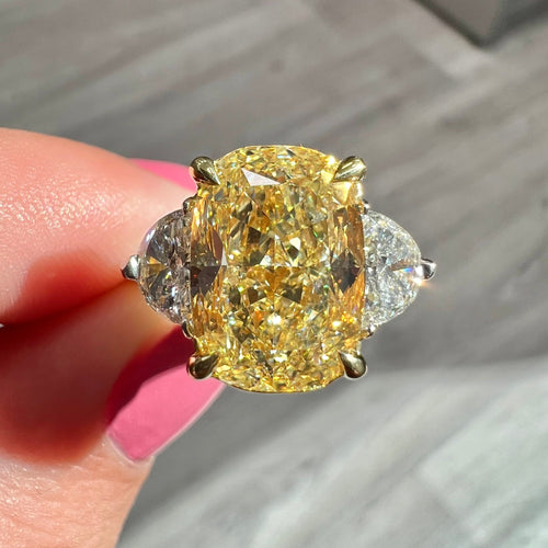 Fancy Yellow Diamond three stone ring. Elongated fancy yellow cushion