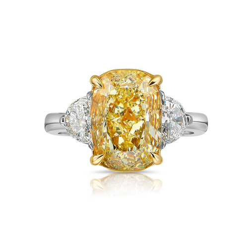 Fancy Yellow Diamond three stone ring. Elongated fancy yellow cushion.