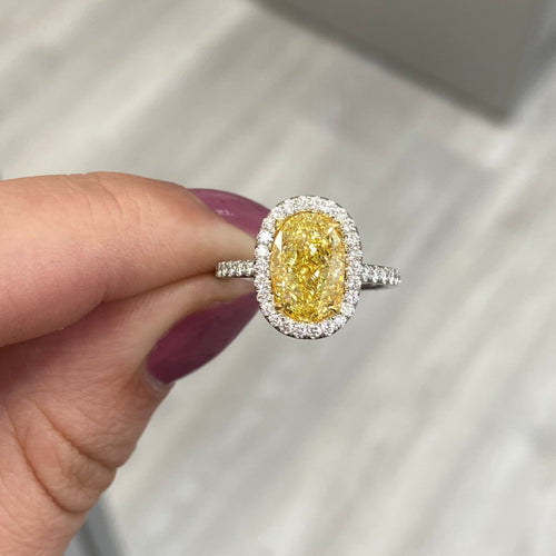 yellow diamond ring with white halo. halo diamond engagement ring. fancy yellow oval. 3 carat oval diamond. yellow diamond engagement ring.