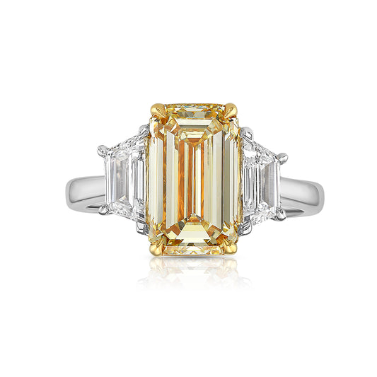 3 carat yellow diamond elongated emerald cut three stone ring with trapezoids. yellow diamond emerald