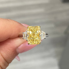 fancy yellow diamond ring. 4 carat yellow diamond. Elongated radiant. long radiant yellow diamond. yellow diamond 3 stone ring