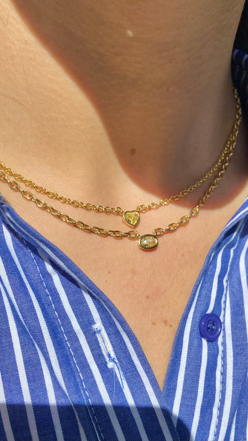 Canary diamond necklace, yellow heart shape diamond on a golden chain, bezel set yellow diamond