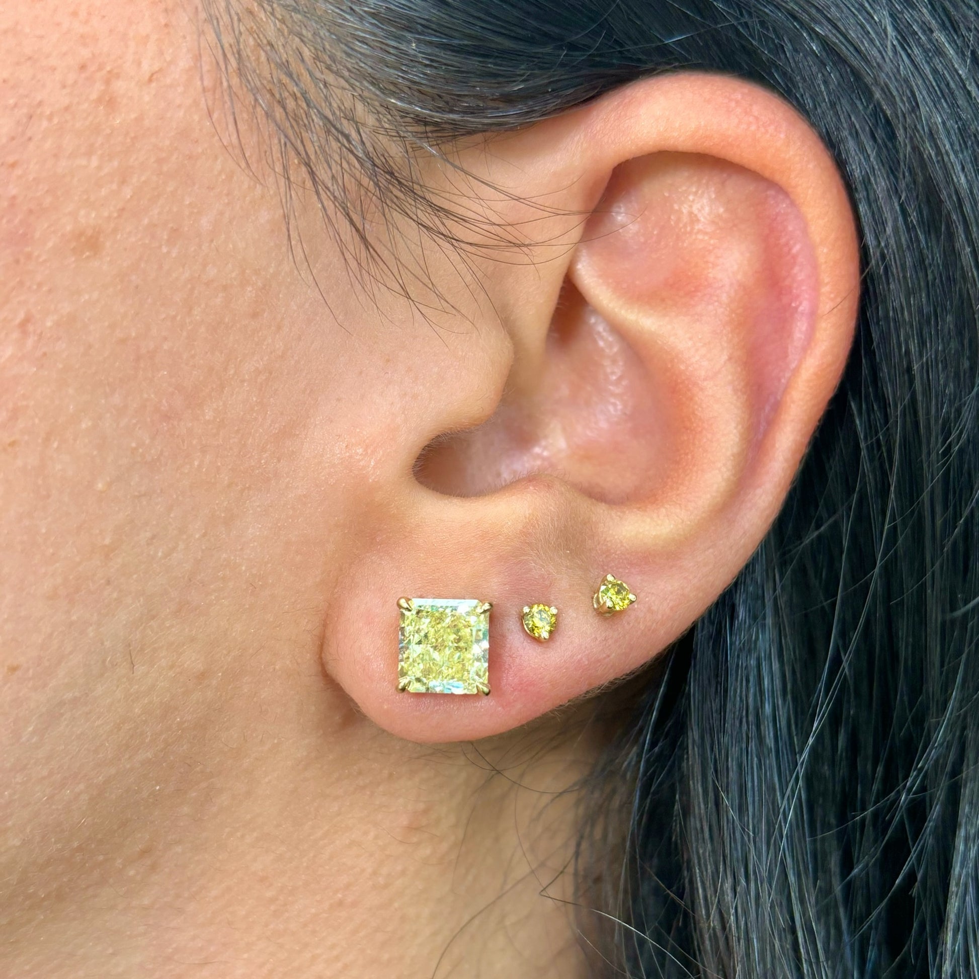 2 Carat each fancy light yellow studs earrings set in 18 karat yellow gold.Fancy light yellow diamond earrings. Yellow diamond earrings. Canary diamond earrings 