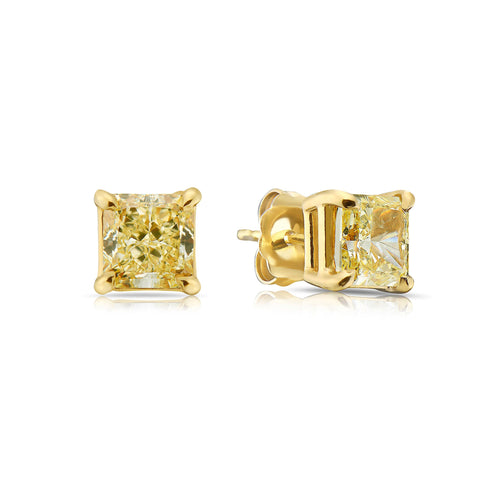 2 Carat each fancy light yellow studs earrings set in 18 karat yellow gold.Fancy light yellow diamond earrings. Yellow diamond earrings. Canary diamond earrings