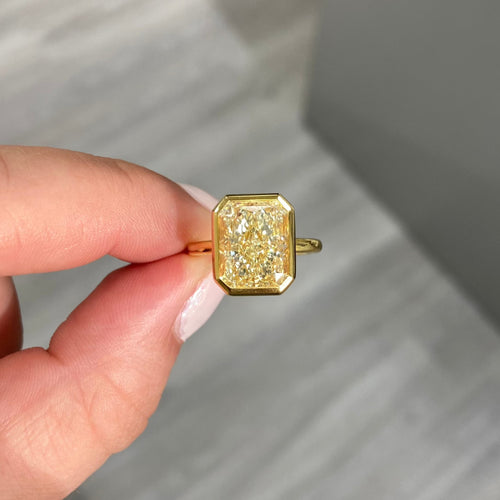 Yellow diamond ring. Fancy yellow diamond ring. yellow diamond bezel ring. yellow diamond jewelry.