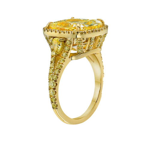 Unique light yellow cushion diamond ring with yellow diamond halo setting.