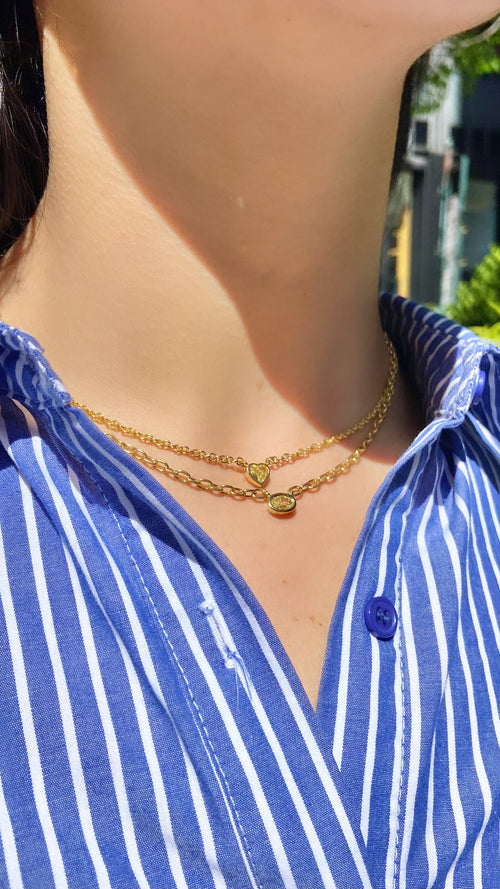 Canary diamond necklace, yellow oval cut diamond on a golden chain, bezel set yellow diamond