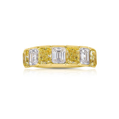 An alternating yellow diamond and white diamond half eternity band, a twist on the classic eternity with diamonds reaching only halfway across the band