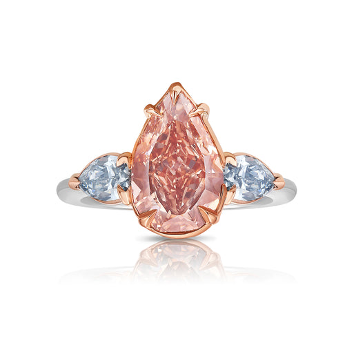 Unique three-stone ring with a deep brown-pink pear diamond and blue diamond accents, GIA certified.