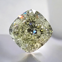 GIA certified faint green cushion cut diamond, showcasing natural green hues in stunning detail.