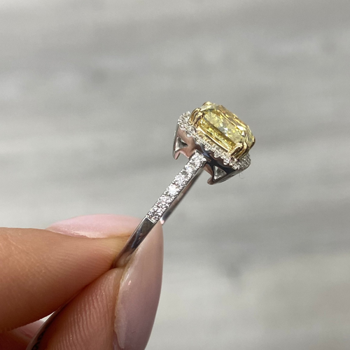 Yellow diamond ring with white halo diamonds