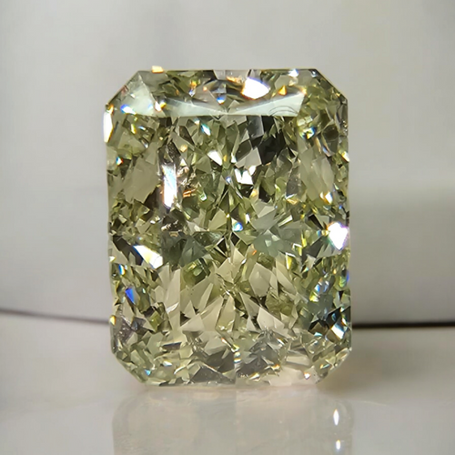 GIA certified Fancy Green-Yellow elongated radiant cut diamond with VVS2 clarity and vibrant color.