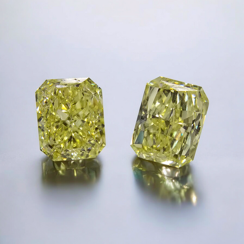 Matched pair of elongated natural yellow diamonds.