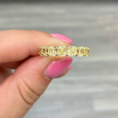 Elegant half eternity band showcasing radiant fancy yellow diamonds in a classic and vibrant design.