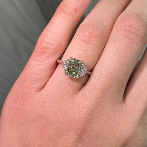 Natural greenish yellow diamond engagement ring featuring a radiant cut center stone with VVS2 clarity.