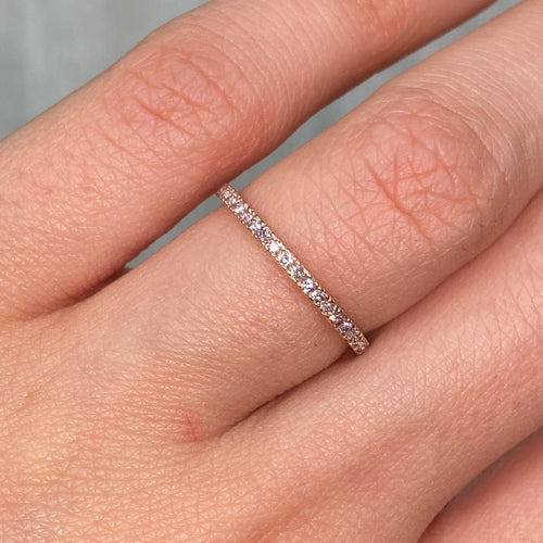 Fancy Pink Diamond Eternity Band with fine pink diamonds set on a sleek rose gold band with a VS-SI clarity.