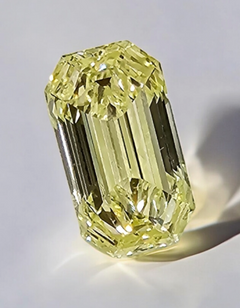 Elegant radiant yellow unique emerald cut with an elongated diamond, GIA certified, VS1 clarity.