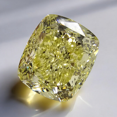 GIA certified fancy yellow cushion cut natural diamond with VS2 clarity and excellent cut.