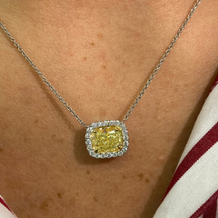 Stunning natural yellow diamond Necklace with White Halo diamonds and a VVS1 clarity.