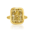 Bezel set ring featuring a GIA certified Fancy Yellow natural diamond with VS1 clarity.