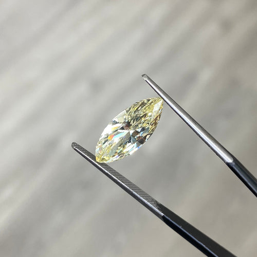 Fancy Yellow marquise cut diamond with VS1 clarity and no fluorescence.