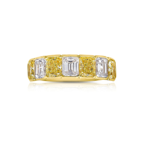 An alternating yellow diamond and white diamond half eternity band, a twist on the classic eternity with diamonds reaching only halfway across the band.