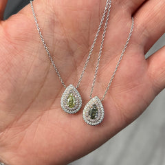 Elegant greenish yellow pear-shaped diamond pendant with a double halo design and unique charm with a SI2 clarity.