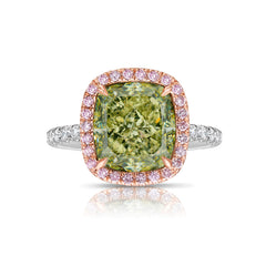 GIA certified greenish yellow cushion diamond in a pink halo engagement ring with VS1 clarity.