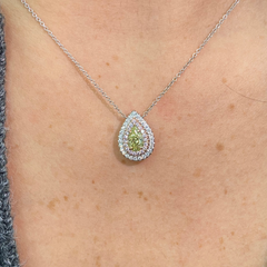 Elegant greenish yellow pear-shaped diamond pendant with a double halo design and unique charm with a SI2 clarity.