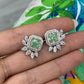 natural green diamond earrings, green diamond stud earrings with white and pink diamonds surrounding