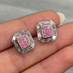 Natural pink elongated radiant diamond studs with GIA certified pink center and white diamond accents.